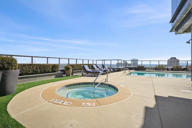 pool featuring a community hot tub, a patio area, and fence