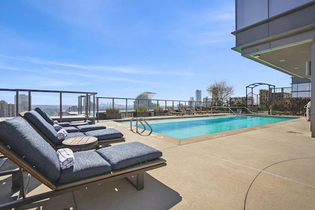 pool featuring fence and a patio