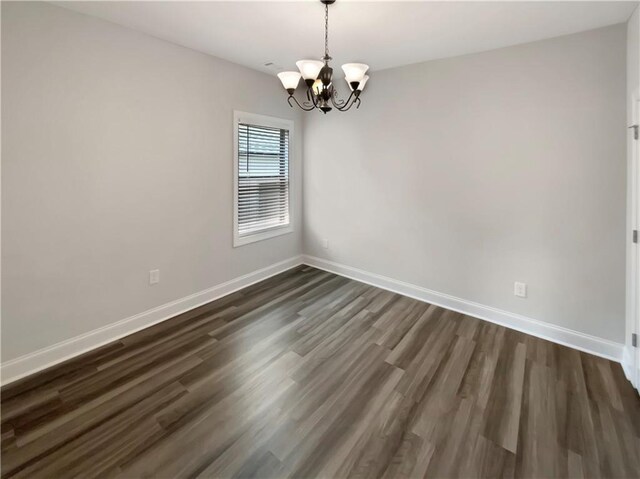 108 Hickory Run, Canton, GA 30115 - empty room featuring dark wood-style flooring, baseboards, and an inviting chandelier