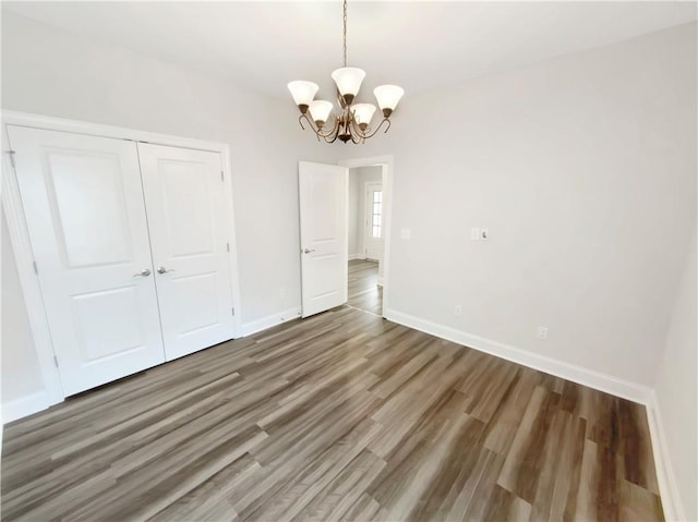 108 Hickory Run, Canton, GA 30115 - unfurnished dining area with baseboards, an inviting chandelier, and wood finished floors