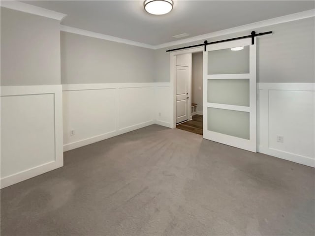 108 Hickory Run, Canton, GA 30115 - unfurnished bedroom featuring crown molding, carpet, wainscoting, and a barn door