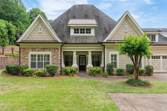 2855 Middlecreek Way Unit 2855, Cumming, GA 30041 - craftsman-style home with a front lawn, covered porch, stone siding, a garage, and roof with shingles