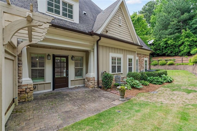 2855 Middlecreek Way Unit 2855, Cumming, GA 30041 - property entrance featuring stone siding, board and batten siding, a shingled roof, and a lawn