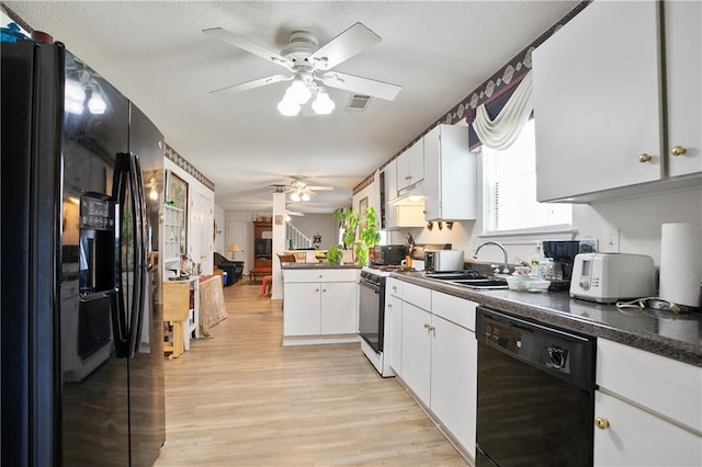 3405 Spring Chase Ln, Ellenwood, GA 30294 - kitchen featuring black appliances, ceiling fan, dark countertops, light wood-type flooring, and white cabinets