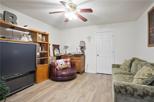 3405 Spring Chase Ln, Ellenwood, GA 30294 - living room with light wood-type flooring, ceiling fan, and a textured ceiling