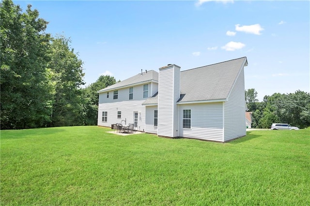 3405 Spring Chase Ln, Ellenwood, GA 30294 - rear view of property featuring a lawn, a patio, and a chimney