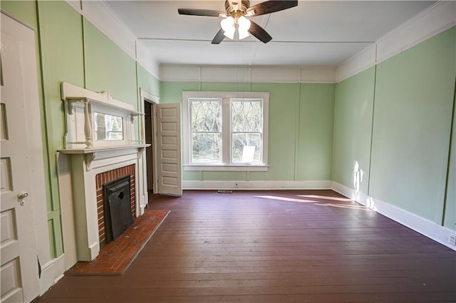 unfurnished living room featuring a brick fireplace, ceiling fan, and dark hardwood / wood-style flooring