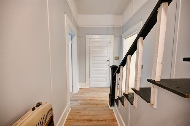 hall featuring heating unit and light wood-type flooring