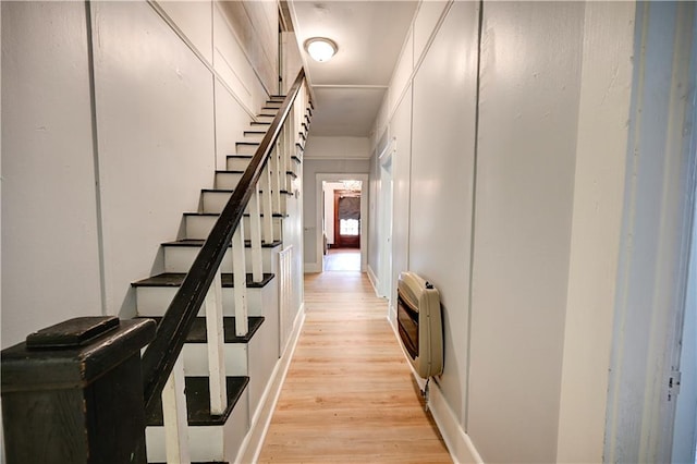 stairway with wood-type flooring and heating unit