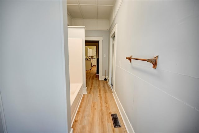 hallway with hardwood / wood-style flooring