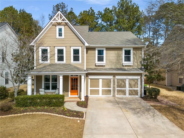 view of front of property with a porch, driveway, and an attached garage