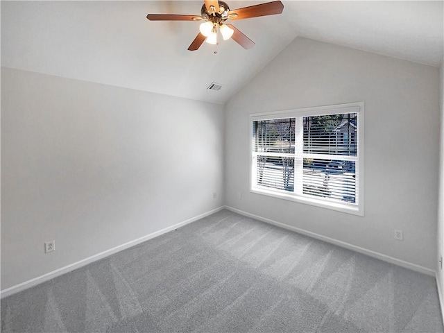 carpeted empty room featuring visible vents, a ceiling fan, baseboards, and vaulted ceiling