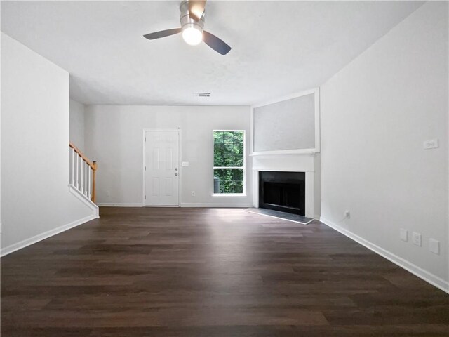 25 Timber Ridge Dr, Cartersville, GA 30121 - unfurnished living room featuring stairway, wood finished floors, a ceiling fan, a fireplace with raised hearth, and baseboards