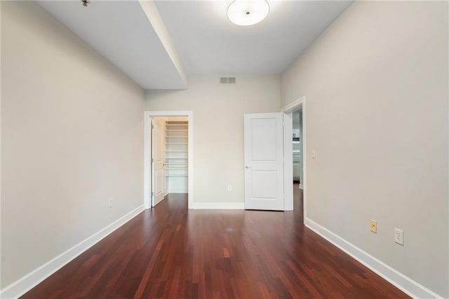 325 E Paces Ferry Rd NE Unit 313, Atlanta, GA 30305 - unfurnished bedroom featuring wood finished floors, baseboards, a spacious closet, and a closet