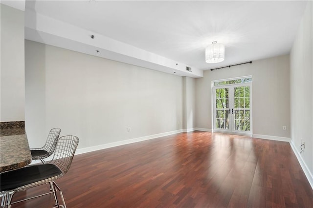 325 E Paces Ferry Rd NE Unit 313, Atlanta, GA 30305 - spare room featuring wood finished floors, a chandelier, and baseboards