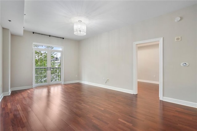 325 E Paces Ferry Rd NE Unit 313, Atlanta, GA 30305 - empty room with a chandelier, wood finished floors, and baseboards