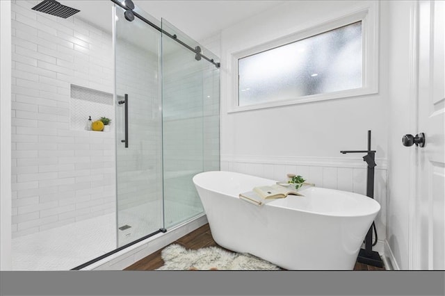 bathroom featuring hardwood / wood-style flooring and independent shower and bath