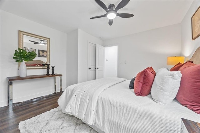 bedroom with dark hardwood / wood-style floors and ceiling fan