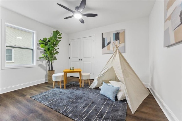 game room with dark hardwood / wood-style floors and ceiling fan