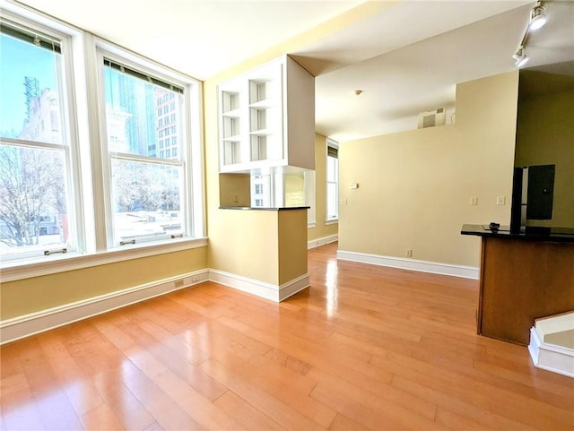 57 Forsyth St NW Unit 4H, Atlanta, GA 30303 - kitchen with wood finished floors, track lighting, baseboards, open shelves, and built in features