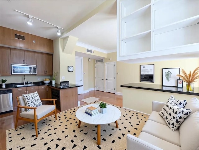 57 Forsyth St NW Unit 4H, Atlanta, GA 30303 - living area featuring track lighting, light wood-style floors, and baseboards