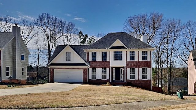 colonial house with a front lawn, brick siding, and driveway