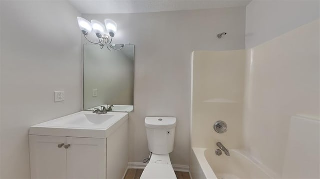 bathroom featuring toilet, vanity, and  shower combination