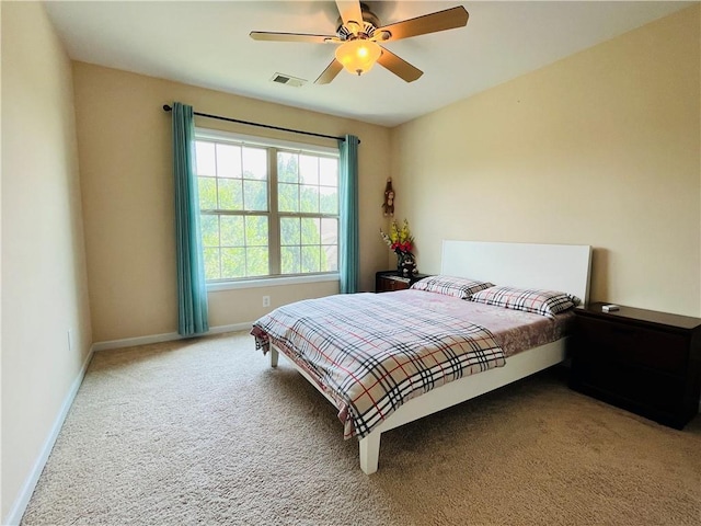 bedroom with carpet floors, visible vents, ceiling fan, and baseboards