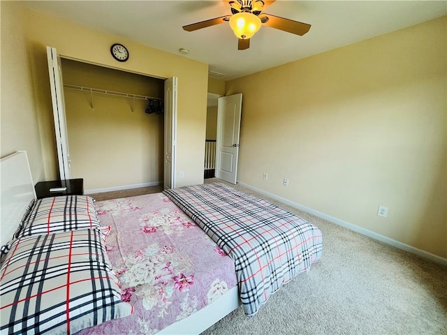 bedroom with ceiling fan, a closet, carpet, and baseboards