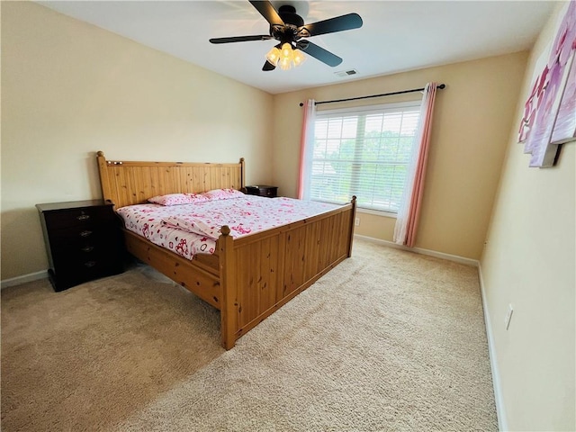 bedroom featuring light carpet, baseboards, visible vents, and a ceiling fan