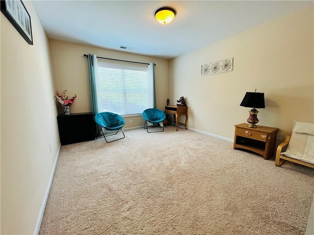 sitting room featuring carpet floors, baseboards, and visible vents