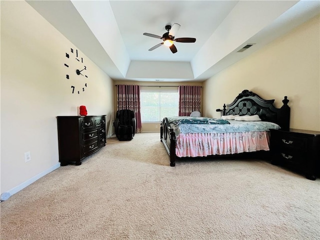 bedroom featuring carpet, a raised ceiling, visible vents, a ceiling fan, and baseboards