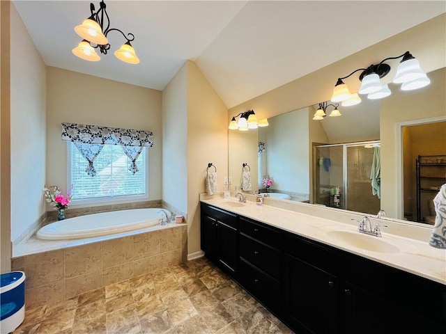 full bathroom with a garden tub, vaulted ceiling, and a sink