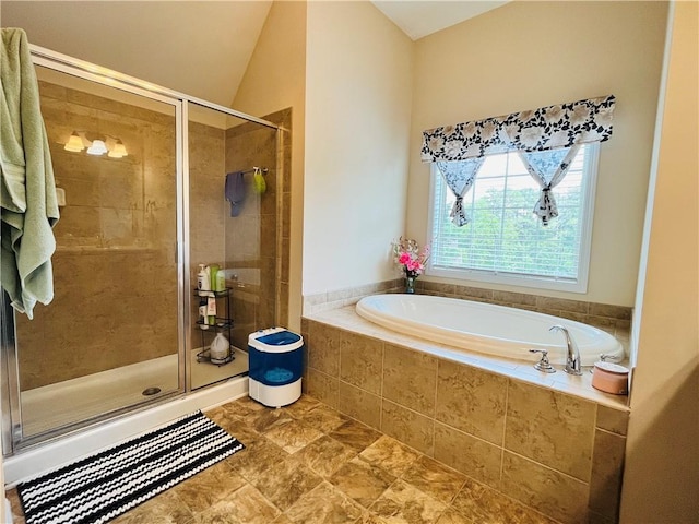 bathroom featuring vaulted ceiling, a shower stall, and a bath