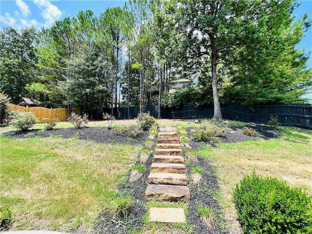 view of yard with fence private yard and stairs