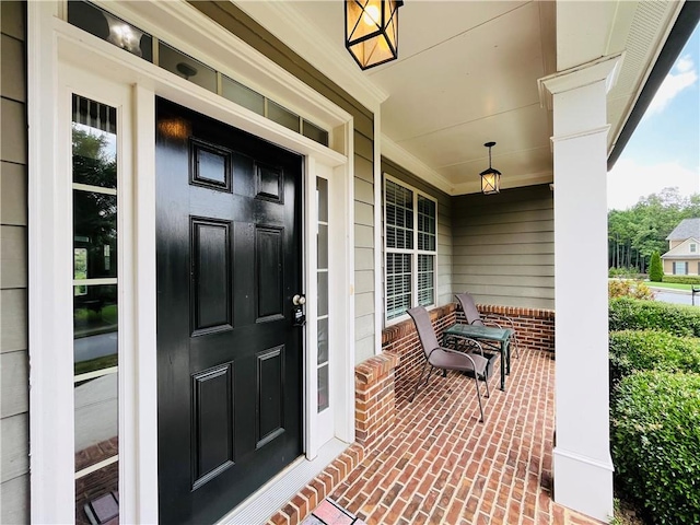 entrance to property featuring covered porch