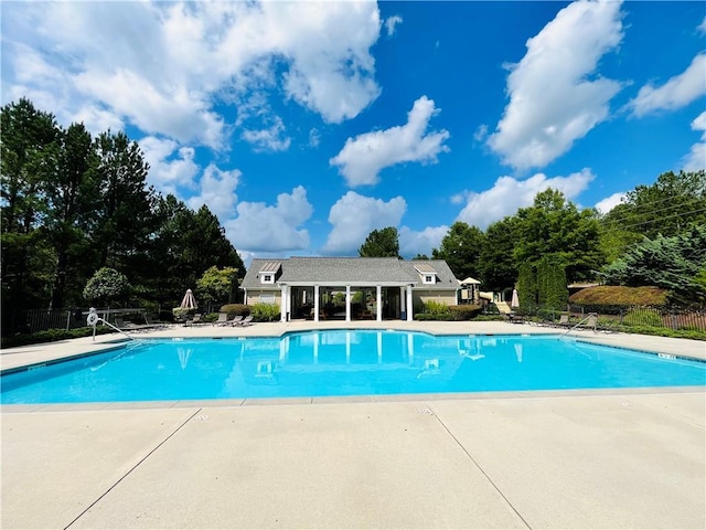 pool featuring a patio area and fence