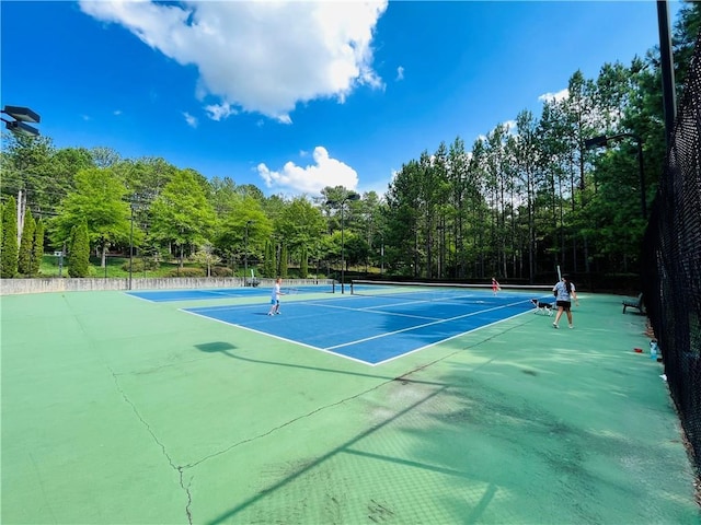 view of sport court featuring fence