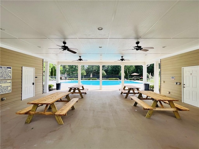 view of patio featuring ceiling fan and a community pool