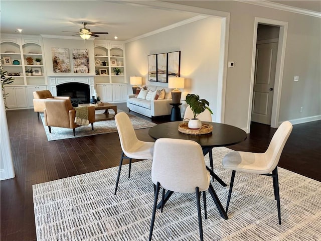7580 Sunridge Ln, Douglasville, GA 30135 - dining space with dark wood-type flooring, ornamental molding, baseboards, and a ceiling fan