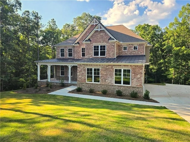 7580 Sunridge Ln, Douglasville, GA 30135 - craftsman inspired home featuring metal roof, a front yard, brick siding, a standing seam roof, and a porch