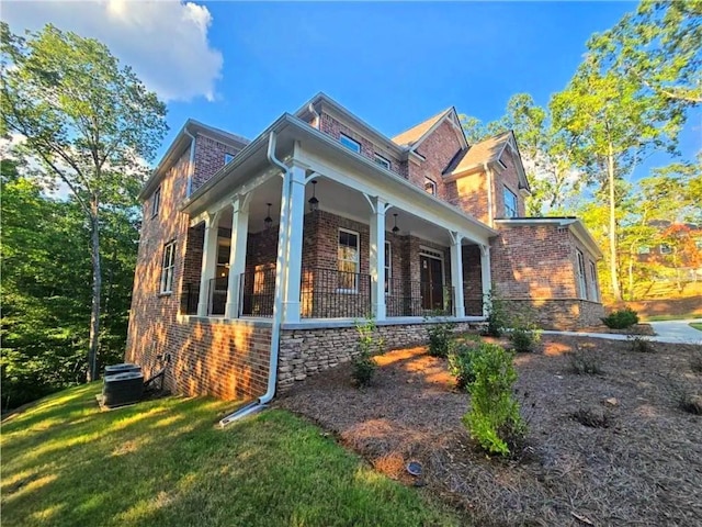 7580 Sunridge Ln, Douglasville, GA 30135 - view of home's exterior featuring covered porch, brick siding, central air condition unit, and a lawn