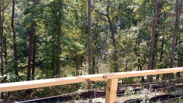 wooden deck with a wooded view