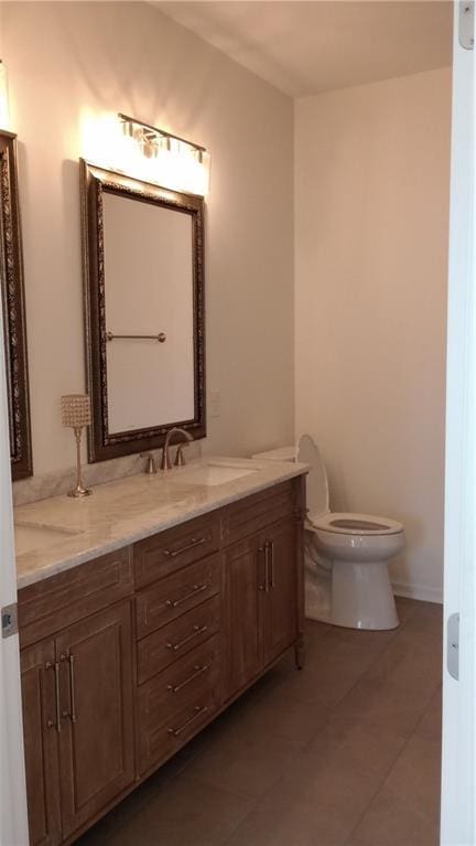 bathroom with vanity, toilet, and tile patterned floors