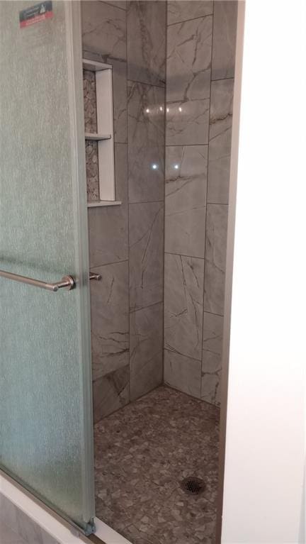 bathroom featuring a shower stall