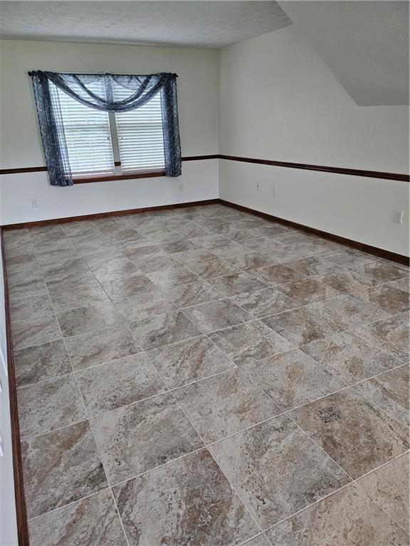 2752 Inverloch Cir, Duluth, GA 30096 - unfurnished room with baseboards and a textured ceiling