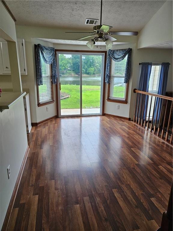 2752 Inverloch Cir, Duluth, GA 30096 - unfurnished dining area with ceiling fan, wood finished floors, a textured ceiling, and baseboards