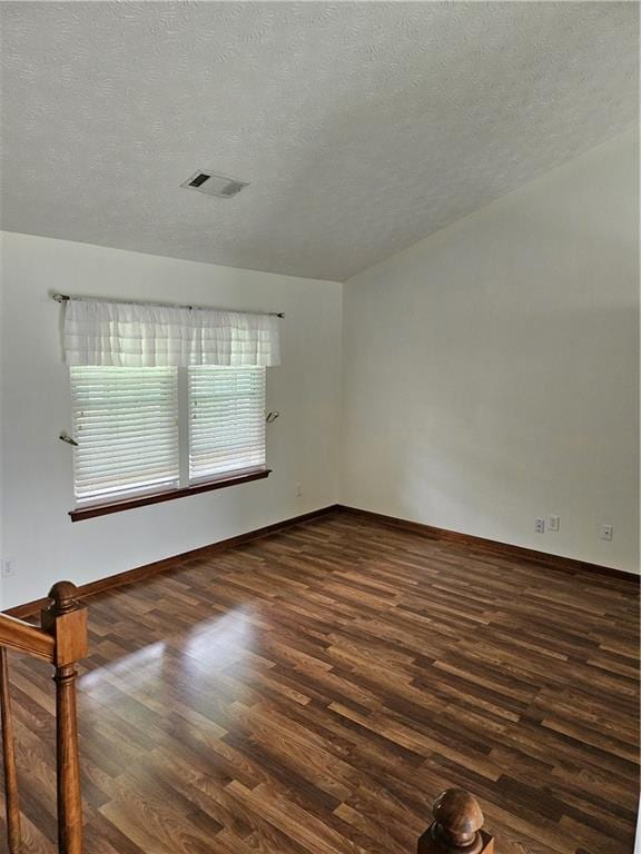 2752 Inverloch Cir, Duluth, GA 30096 - empty room with dark wood-style floors, a textured ceiling, and baseboards