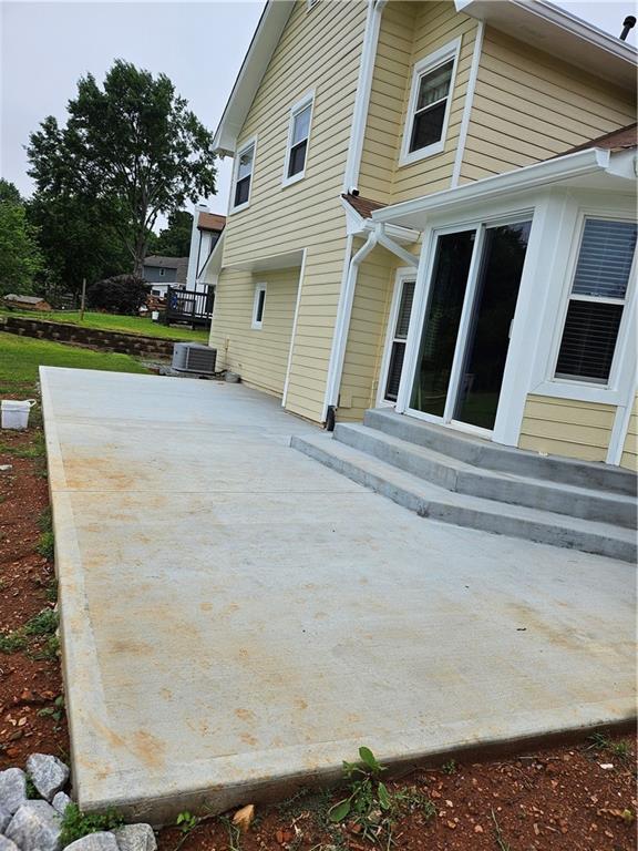 2752 Inverloch Cir, Duluth, GA 30096 - back of house featuring entry steps, a patio area, and cooling unit