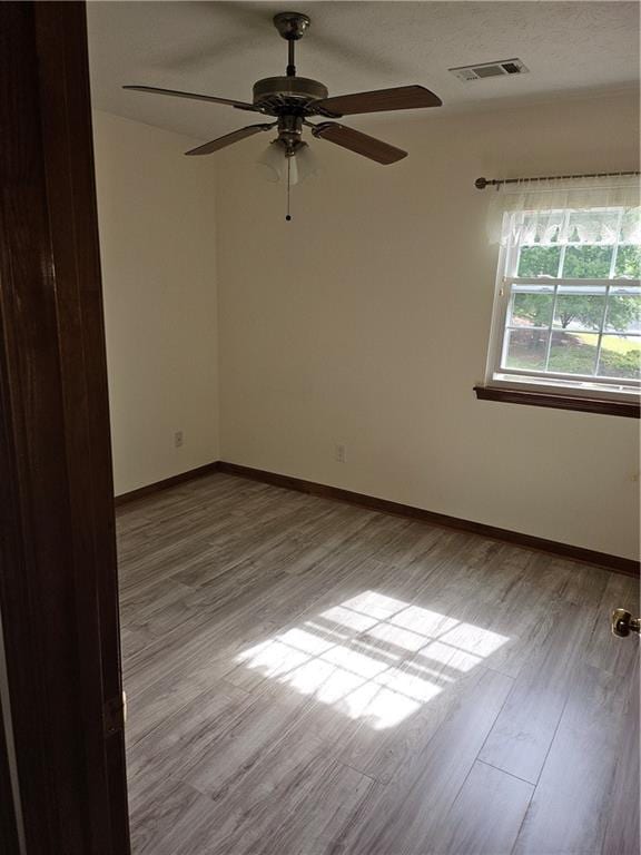 2752 Inverloch Cir, Duluth, GA 30096 - spare room with wood finished floors, ceiling fan, and baseboards